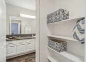 Thumbnail 10 of 32 - A bathroom with white cabinets and a mirror.