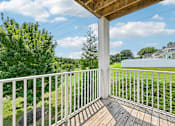 Thumbnail 19 of 48 - A wooden deck at Hawks Landing in Hickory NC with a white railing overlooking a green lawn and trees