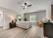 Thumbnail 21 of 29 - Houses in Lady Lake for Rent – The Groves at Lake Ella - a bedroom with a bed and a ceiling fan