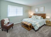 Thumbnail 13 of 40 - Grand Arbor Reserve Apartments in Raleigh, NC photo of a bedroom with plus hcarpeting and a large window