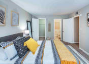 Thumbnail 10 of 40 - Grand Arbor Reserve Apartments in Raleigh, NC photo of a bedroom with an attached bathroom and walkin closet