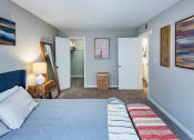 Thumbnail 5 of 40 - Grand Arbor Reserve Apartments in Raleigh, NC photo of a bedroom with a bed and a mirror