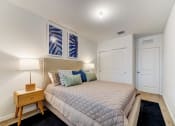 Thumbnail 16 of 30 - Boatman Hammock Townhomes in Lake Worth, FL photo of  a bedroom with a large bed and two windows
