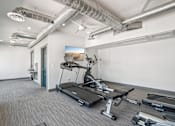 Thumbnail 13 of 34 - A gym with treadmills, weights, and exercise equipment.