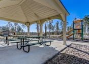 Thumbnail 52 of 56 - a picnic shelter with a playground in the background
