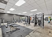 Thumbnail 60 of 66 - A gym with a variety of equipment including a leg press machine.