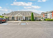 Thumbnail 38 of 48 - A parking area at the Hawks Landing leasing office in Hickory NC with a tree in the background