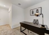 Thumbnail 19 of 30 - Boatman Hammock Townhomes in Lake Worth, FL photo of  a home office with a desk and a lamp and a white door