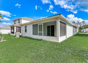 Thumbnail 47 of 56 - a home with a green lawn and a blue sky in the background