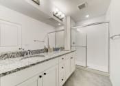 Thumbnail 23 of 30 - Boatman Hammock Townhomes in Lake Worth, FL photo of  a bathroom with white cabinets and a sink and a shower