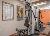 Thumbnail 8 of 16 - A woman is working out on a gym machine.