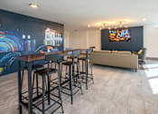 Thumbnail 15 of 20 - Community clubhouse at Idlewild 45 Apartments in Memphis featuring bar seating and entertainment space