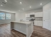 Thumbnail 8 of 21 - a kitchen with an island and white cabinets
