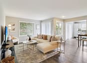 Thumbnail 5 of 15 - Spacious living room with neutral décor and large windows at Ashford at Geneva – pet-friendly apartments in Geneva, IL 60134