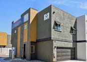 Thumbnail 41 of 45 - A modern building with a garage door and a sign that reads "C 43-19".