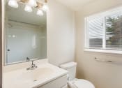 Thumbnail 11 of 48 - renovated bathroom with white vanity and window
