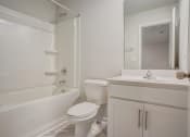 Thumbnail 12 of 19 - a bathroom with a toilet sink and bathtub
