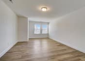 Thumbnail 17 of 20 - a bedroom with hardwood floors and a large window
