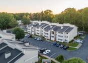 Thumbnail 3 of 20 - an aerial view of an apartment complex with cars parked in a parking lot