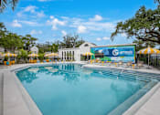 Thumbnail 3 of 34 - A large swimming pool with a Genesis sign in the background.