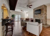 Thumbnail 12 of 15 - Derby Park Apartments in Daytona Beach, FL photo of the clubhouse with seating and a fireplace