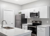 Thumbnail 1 of 16 - St. Ives Crossing apartments in Stockbridge Georgia photo of kitchen with granite countertops