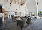 Thumbnail 46 of 46 - A modern living room with a fireplace and grey chairs.