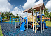 Thumbnail 14 of 28 - A playground with a blue slide and yellow railings.
