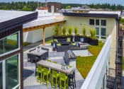 Thumbnail 10 of 36 - Urban Studio Apartments in Seattle, WA - Origin - Rooftop Patio with City View, Fire-Pit, Barbecue Grills, and Lounge Seating