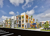 Thumbnail 31 of 36 - Gateway Luxury Apartments building exterior featuring modern architecture and an adjacent playground.
