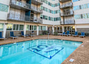 Thumbnail 2 of 20 - Resort-style pool at Idlewild 45 Apartments in Midtown Memphis surrounded by a high-rise courtyard