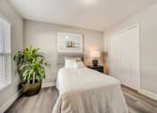 Thumbnail 27 of 29 - Houses in Lady Lake for Rent – The Groves at Lake Ella - guest bedroom with hardwood floors and a bed