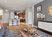 Thumbnail 5 of 16 - Open-concept living room and dining space at 33hundred Apartments in Austin featuring modern finishes, wood-style flooring, and spacious layouts