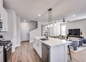 Thumbnail 9 of 47 - A modern kitchen with a large island and stainless steel appliances.