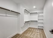 Thumbnail 20 of 47 - A white closet with shelves and a carpeted floor.