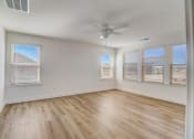 Thumbnail 13 of 20 - an empty bedroom with hardwood floors and a ceiling fan
