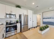 Thumbnail 4 of 56 - a kitchen with white cabinets and stainless steel appliances