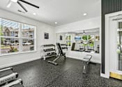Thumbnail 39 of 48 - A spacious Hawks Landing fitness center in Hickory NC featuring dumbbells, weight machines, and a treadmill