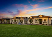 Thumbnail 1 of 55 - A row of houses with a green lawn in front.