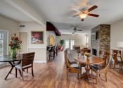 Thumbnail 14 of 15 - Derby Park Apartments in Daytona Beach, FL photo of a living room with a dining room table and a fireplace
