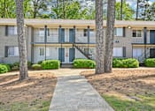 Thumbnail 19 of 20 - Apartment building exterior at Amber Grove in Marietta Georgia with mature landscaping