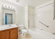 Thumbnail 5 of 32 - A white bathroom with a toilet, sink, and bathtub.