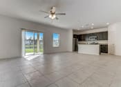 Thumbnail 43 of 56 - a kitchen and living room with a sliding glass door