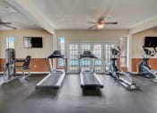 Thumbnail 11 of 15 - Derby Park Apartments in Daytona Beach, FL photo of fitness center with cardio equipment.