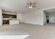 Thumbnail 42 of 56 - a kitchen and living room with a ceiling fan