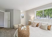 Thumbnail 6 of 15 - Bright bedroom with plush bedding and natural light at Ashford at Geneva – pet-friendly apartments in Geneva, Illinois