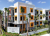 Thumbnail 35 of 36 - Exterior view of Gateway Luxury Apartments with clear property signage and contemporary building design.
