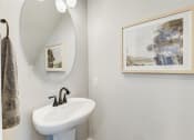 Thumbnail 28 of 56 - a bathroom with a sink and a mirror