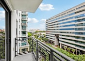 Thumbnail 12 of 30 - Scenic balcony view from MB Station apartments showcasing Miami city views and convenient access to Coral Gables, Brickell, and Downtown Miami.