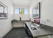 Thumbnail 41 of 46 - A modern office space with a desk, chair, and computer.